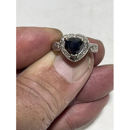 95 - A 14ct white gold ring with heart shaped black diamond centre piece surrounded by diamonds. size M. ... 