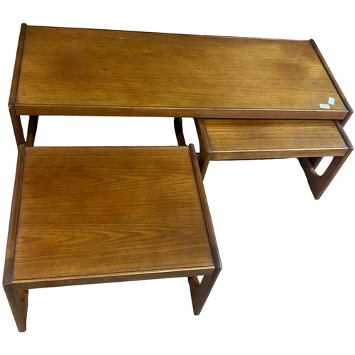 84 - A Trio of Mid-Century Teak Nesting Tables comprising of a coffee table ( 122cm x 46cm x 39cm) and tw... 