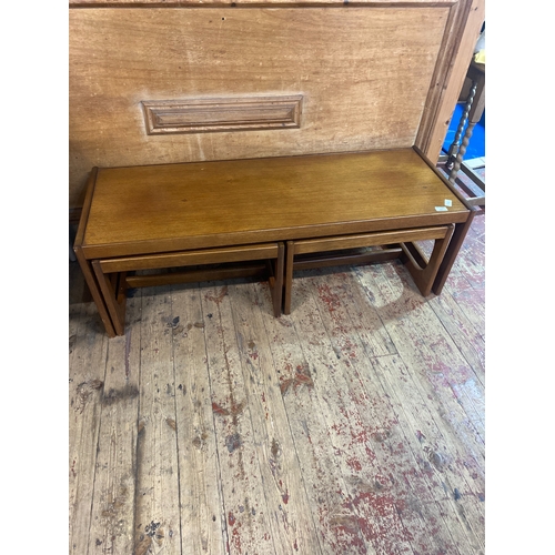 84 - A Trio of Mid-Century Teak Nesting Tables comprising of a coffee table ( 122cm x 46cm x 39cm) and tw... 
