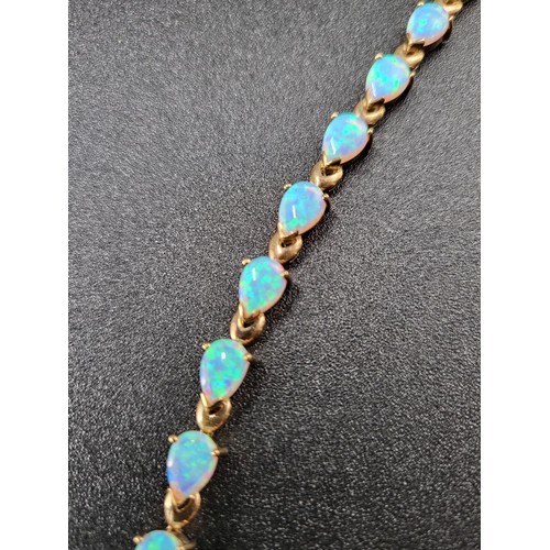 69 - 9ct Gold Fiery Opal Tennis Bracelet 17 Opals in Total Fully Hallmarked Measures 16cm unclasped (Weig... 