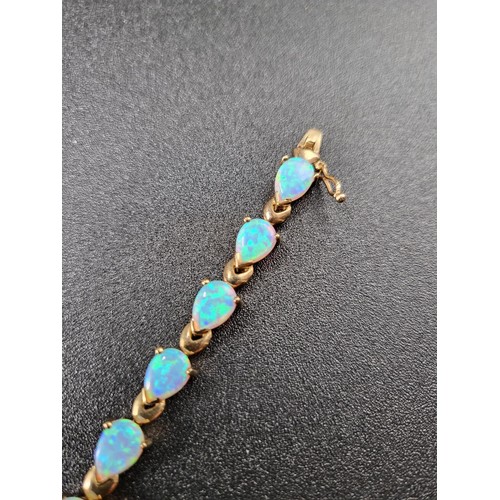 69 - 9ct Gold Fiery Opal Tennis Bracelet 17 Opals in Total Fully Hallmarked Measures 16cm unclasped (Weig... 