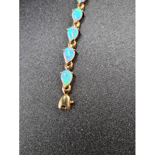 69 - 9ct Gold Fiery Opal Tennis Bracelet 17 Opals in Total Fully Hallmarked Measures 16cm unclasped (Weig... 