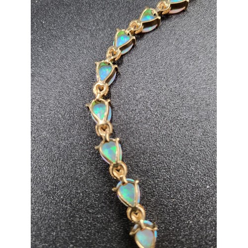 69 - 9ct Gold Fiery Opal Tennis Bracelet 17 Opals in Total Fully Hallmarked Measures 16cm unclasped (Weig... 