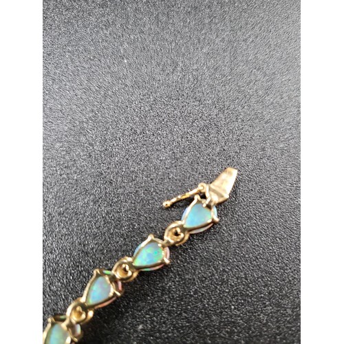 69 - 9ct Gold Fiery Opal Tennis Bracelet 17 Opals in Total Fully Hallmarked Measures 16cm unclasped (Weig... 