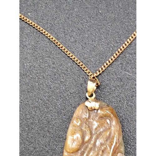 269 - Small Jade Pendant on a 9ct Gold Plated Chain Jade Measures 4.5cm Tall By 2.5cm Wide