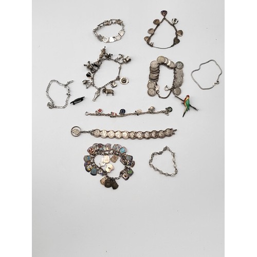 85 - Collection of Silver Charm Bracelets along with Two Brooches ( Total Weight 173g)