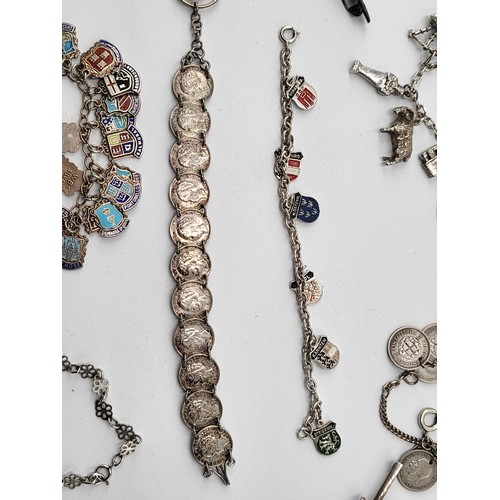 85 - Collection of Silver Charm Bracelets along with Two Brooches ( Total Weight 173g)