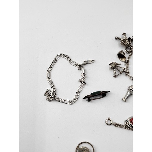 85 - Collection of Silver Charm Bracelets along with Two Brooches ( Total Weight 173g)