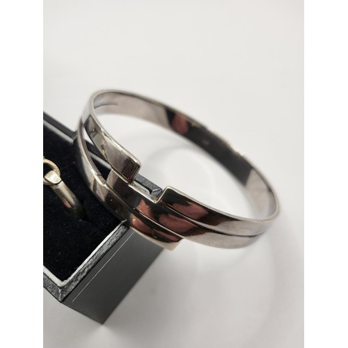 104 - Sterling Silver Mackintosh Bangle along with a 925 Modern Design Bangle Complete Weight 50g