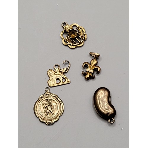 34 - Five 9ct Gold Charms Weighs 4.8g Includes Thistle, Bean, Scouts Badge, Lion, 