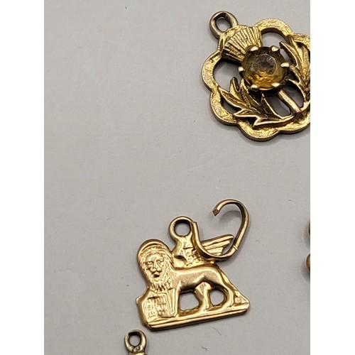 34 - Five 9ct Gold Charms Weighs 4.8g Includes Thistle, Bean, Scouts Badge, Lion, 