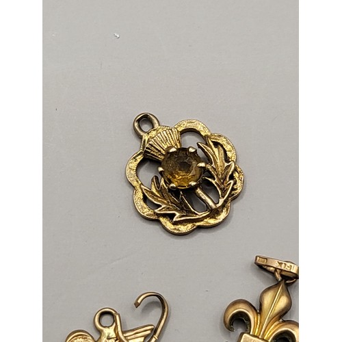 34 - Five 9ct Gold Charms Weighs 4.8g Includes Thistle, Bean, Scouts Badge, Lion, 