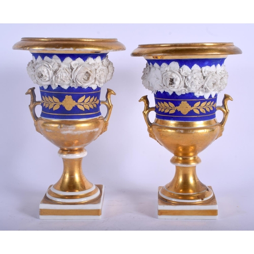 106 - A PAIR OF 19TH CENTURY FRENCH PARIS PORCELAIN PEDESTAL VASES encrusted with flowers. 20 cm high.