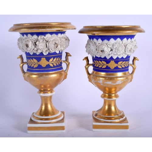 106 - A PAIR OF 19TH CENTURY FRENCH PARIS PORCELAIN PEDESTAL VASES encrusted with flowers. 20 cm high.