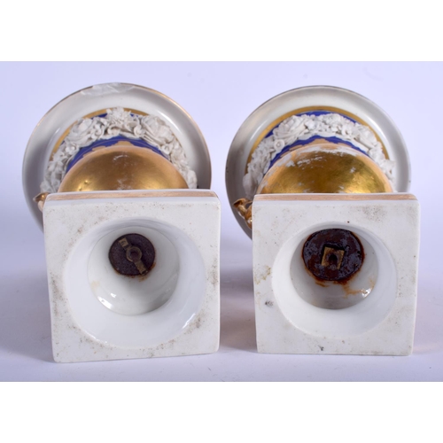106 - A PAIR OF 19TH CENTURY FRENCH PARIS PORCELAIN PEDESTAL VASES encrusted with flowers. 20 cm high.