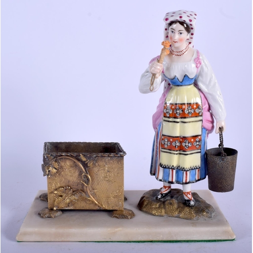 112 - A RARE EARLY 20TH CENTURY RUSSIAN PORCELAIN FIGURE OF A FEMALE modelled beside a brass dish. 17 cm x... 