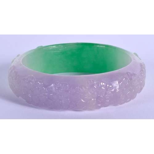 1203 - A CHINESE JADEITE FLOWER BANGLE 20th Century. 8 cm wide.