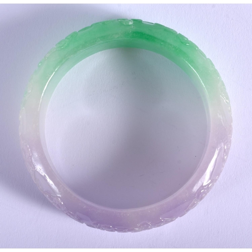 1203 - A CHINESE JADEITE FLOWER BANGLE 20th Century. 8 cm wide.