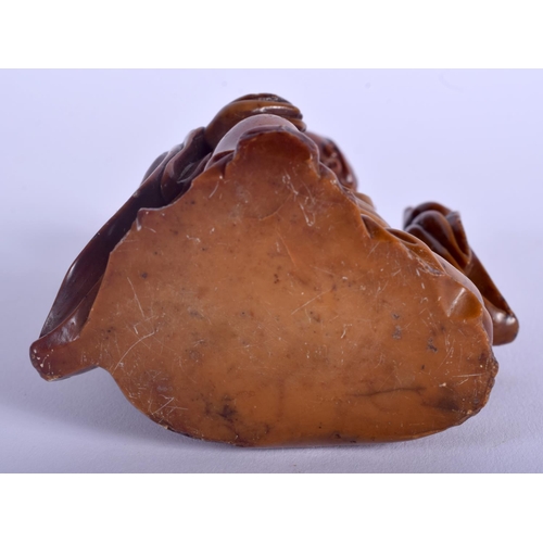 1215 - A 19TH CENTURY CHINESE CARVED SOAPSTONE FIGURE OF AN IMMORTAL Qing, modelled beside a dragon. 9 cm x... 