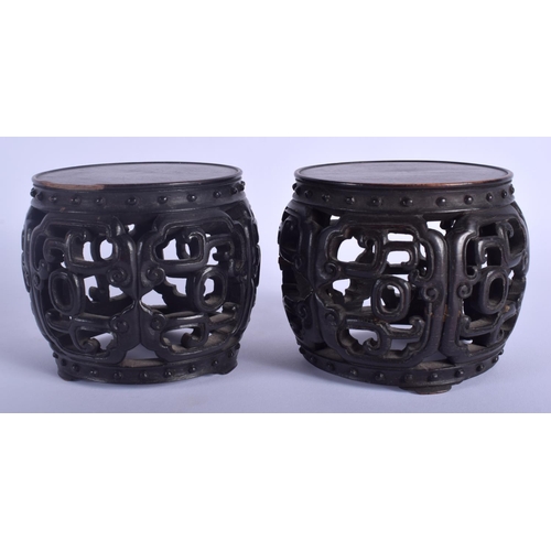 1227 - A RARE PAIR OF 19TH CENTURY CHINESE BARREL SHAPED HONGMU STANDS Qing, possibly zitan. 9 cm x 7 cm.