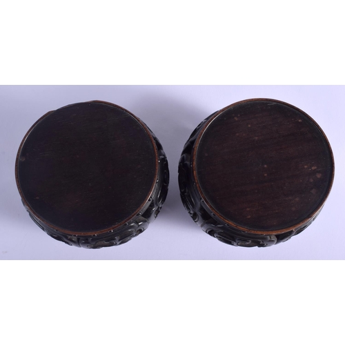 1227 - A RARE PAIR OF 19TH CENTURY CHINESE BARREL SHAPED HONGMU STANDS Qing, possibly zitan. 9 cm x 7 cm.