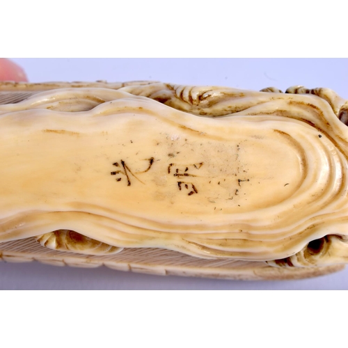 1242 - A 19TH CENTURY JAPANESE MEIJI PERIOD CARVED IVORY OKIMONO modelled as figures beside an octopus. 17 ... 