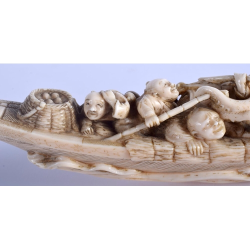 1242 - A 19TH CENTURY JAPANESE MEIJI PERIOD CARVED IVORY OKIMONO modelled as figures beside an octopus. 17 ... 