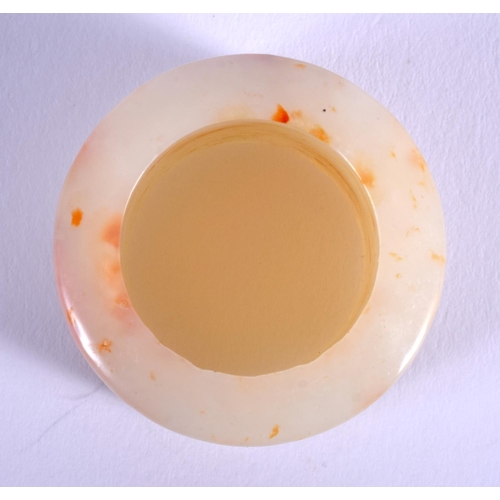 1250 - A 19TH CENTURY CHINESE CARVED GREYISH WHITE JADE ARCHERS Qing, with red inclusions. 2.75 cm wide.