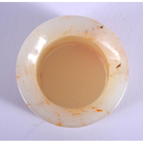 1250 - A 19TH CENTURY CHINESE CARVED GREYISH WHITE JADE ARCHERS Qing, with red inclusions. 2.75 cm wide.