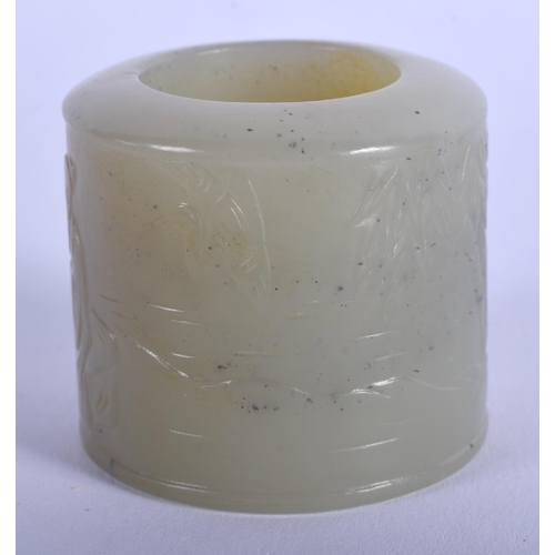 1251 - A 19TH CENTURY CHINESE CARVED GREEN JADE ARCHERS RING Qing, decorated with figures within landscapes... 