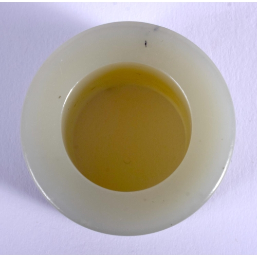 1251 - A 19TH CENTURY CHINESE CARVED GREEN JADE ARCHERS RING Qing, decorated with figures within landscapes... 