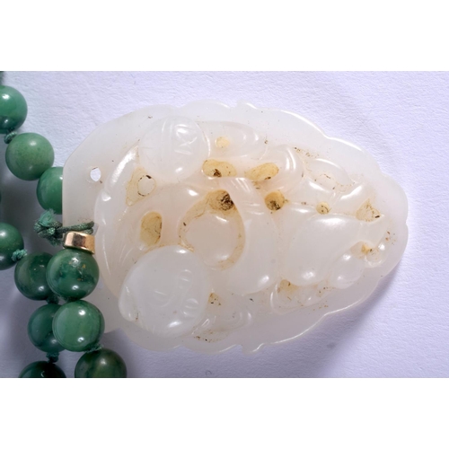1256 - AN EARLY 20TH CENTURY CHINESE CARVED JADEITE AND GREEN JADE NECKLACE Late Qing/Republic. Pendant 4 c... 