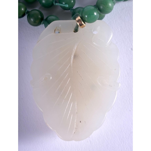 1256 - AN EARLY 20TH CENTURY CHINESE CARVED JADEITE AND GREEN JADE NECKLACE Late Qing/Republic. Pendant 4 c... 