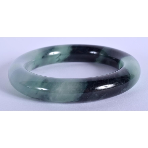 1270 - AN EARLY 20TH CENTURY CHINESE CARVED ICEY JADEITE BANGLE Late Qing/Republic. 8 cm diameter.