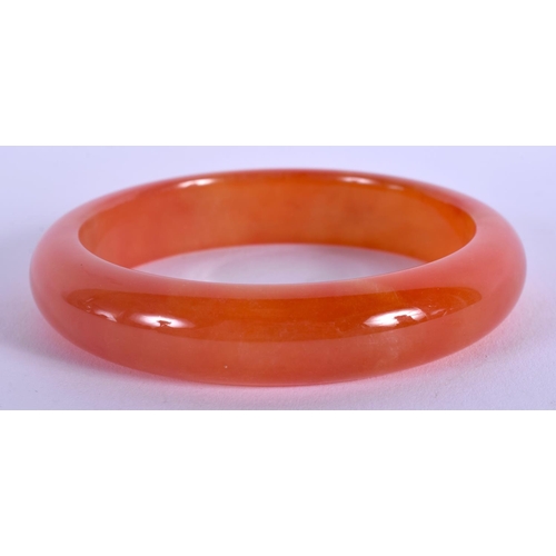 1271 - AN EARLY 20TH CENTURY CHINESE CARVED ORANGE JADE AGATE BANGLE Late Qing/Republic. 6.5 cm wide.