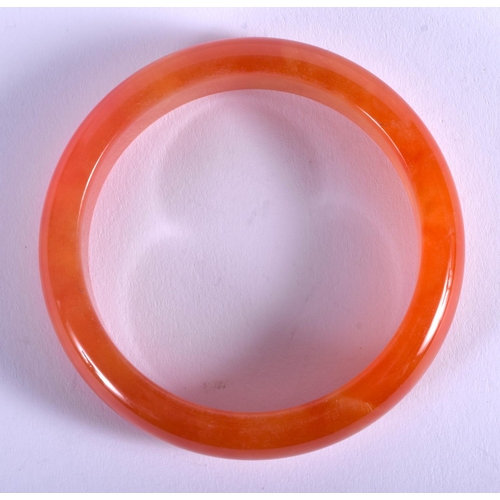 1271 - AN EARLY 20TH CENTURY CHINESE CARVED ORANGE JADE AGATE BANGLE Late Qing/Republic. 6.5 cm wide.