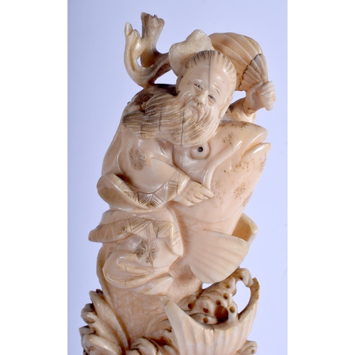 1282 - A LARGE 19TH CENTURY JAPANESE MEIJI PERIOD CARVED IVORY OKIMONO modelled as a male holding aloft a l... 