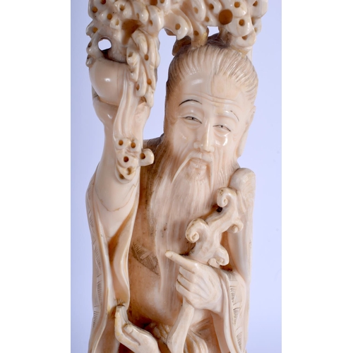 1282 - A LARGE 19TH CENTURY JAPANESE MEIJI PERIOD CARVED IVORY OKIMONO modelled as a male holding aloft a l... 