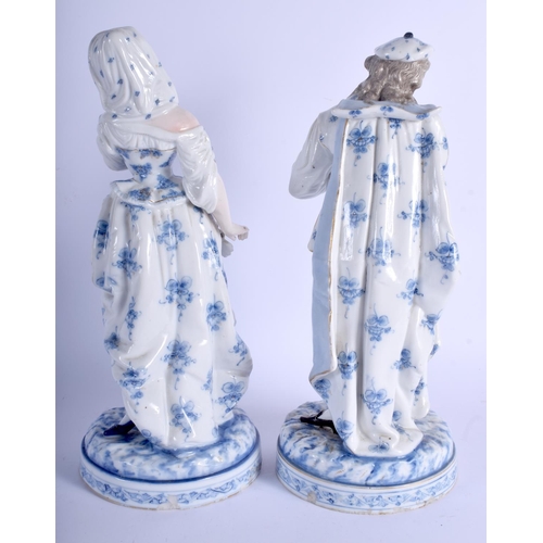 220 - A LARGE PAIR OF 19TH CENTURY GERMAN PORCELAIN FIGURES probably Meissen, painted with blue and white ... 