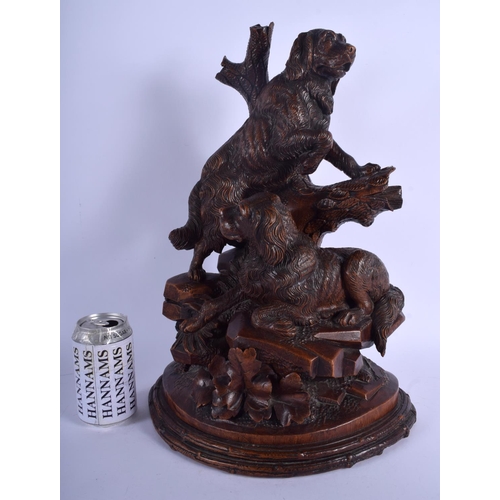 301 - A LARGE 19TH CENTURY BAVARIAN BLACK FOREST CARVED WOOD FIGURAL GROUP modelled as two hounds upon a r... 