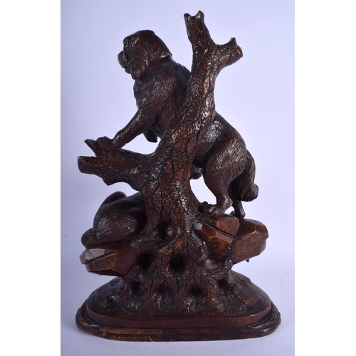 301 - A LARGE 19TH CENTURY BAVARIAN BLACK FOREST CARVED WOOD FIGURAL GROUP modelled as two hounds upon a r... 