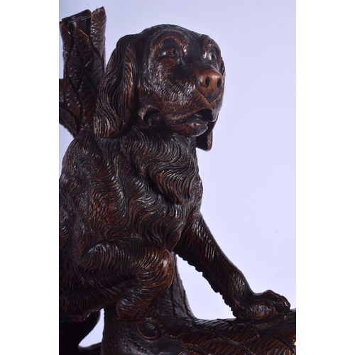 301 - A LARGE 19TH CENTURY BAVARIAN BLACK FOREST CARVED WOOD FIGURAL GROUP modelled as two hounds upon a r... 