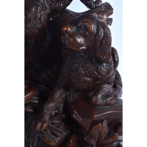 301 - A LARGE 19TH CENTURY BAVARIAN BLACK FOREST CARVED WOOD FIGURAL GROUP modelled as two hounds upon a r... 