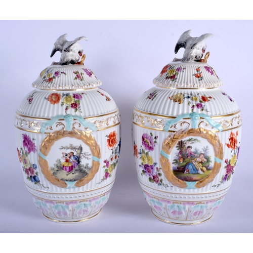 55 - A LARGE PAIR OF EARLY 20TH CENTURY DRESDEN PORCELAIN VASES AND COVERS Meissen style, painted with fl... 