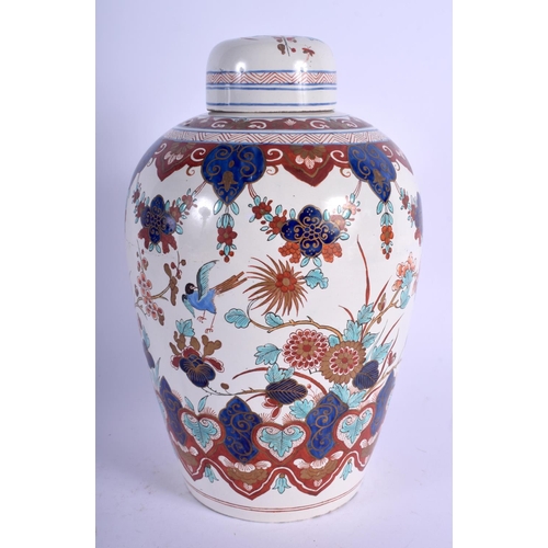 63 - AN 18TH/19TH CENTURY DUTCH DELFT FAIENCE GLAZED JAR AND COVER painted with birds and flowers. 24 cm ... 