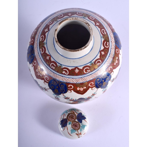 63 - AN 18TH/19TH CENTURY DUTCH DELFT FAIENCE GLAZED JAR AND COVER painted with birds and flowers. 24 cm ... 