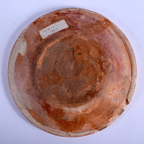 66 - AN 18TH CENTURY DUTCH POTTERY SLIP DECORATED DISH painted with a marbleised motifs. 18 cm diameter.