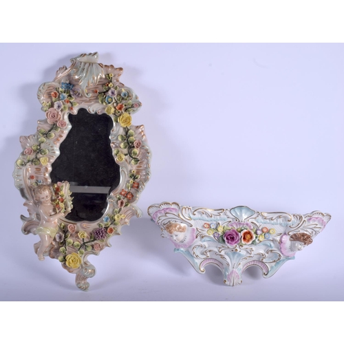 69 - A CONTINENTAL PORCELAIN WALL BRACKET together with a mirror. 46 cm & 34 cm long. (2)