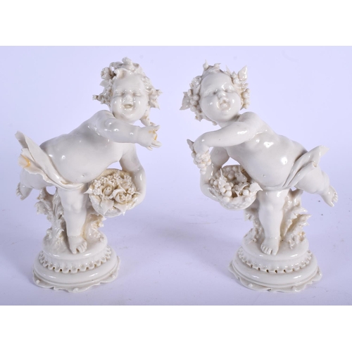 72 - A PAIR OF EARLY 20TH CENTURY WHITE GLAZED PORCELAIN FIGURES modelled upon a shaped base. 16 cm high.