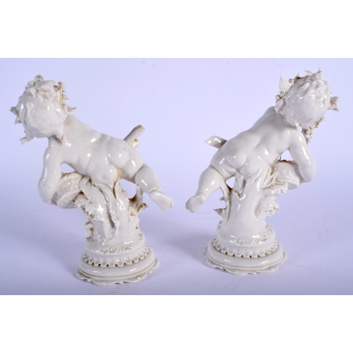 72 - A PAIR OF EARLY 20TH CENTURY WHITE GLAZED PORCELAIN FIGURES modelled upon a shaped base. 16 cm high.